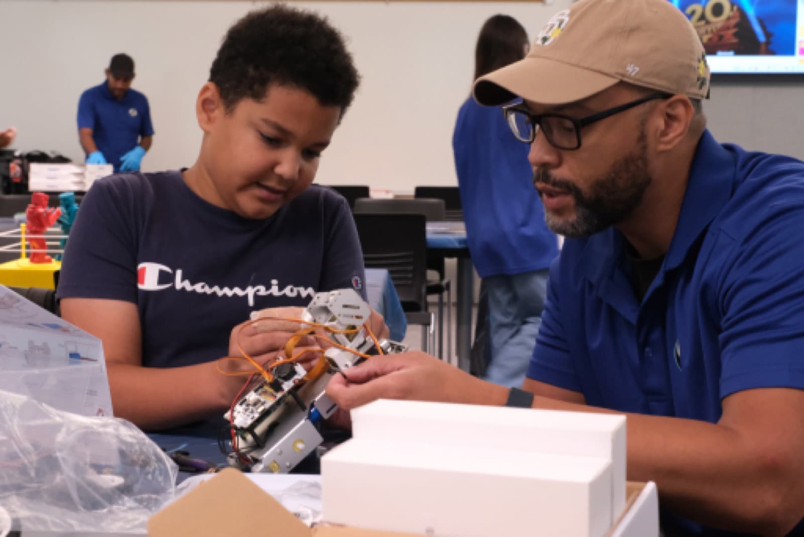 Instructor guiding a student through a break-camp engineering project