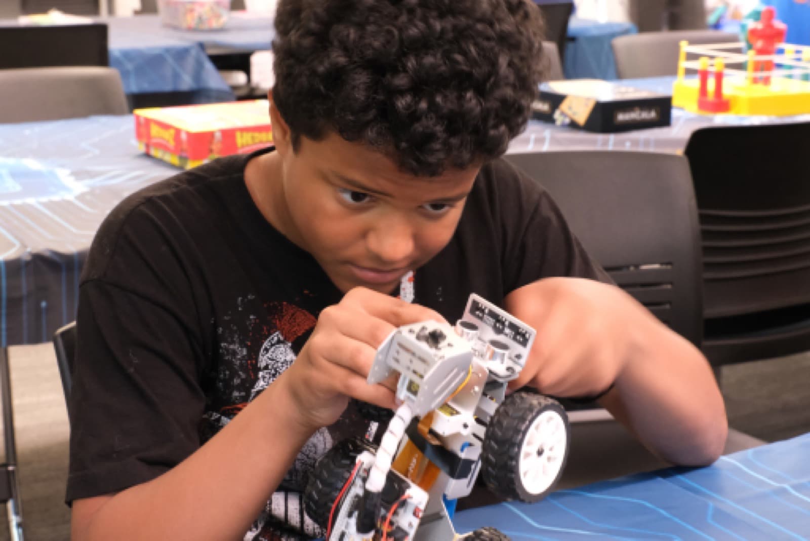 Student building a robot at a recreation STEM program